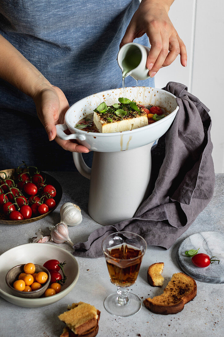 Baked feta cheese with cherry tomatoes and herbs