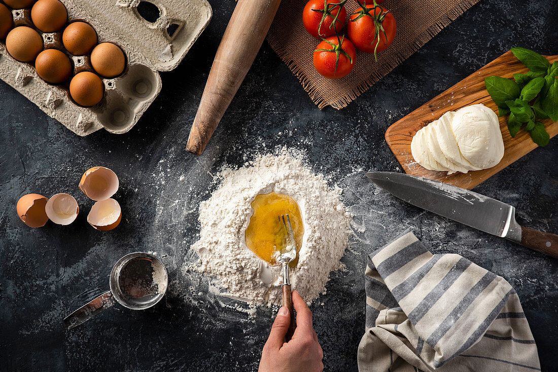 Dough ingredients, tomatoes, mozzarella and basil