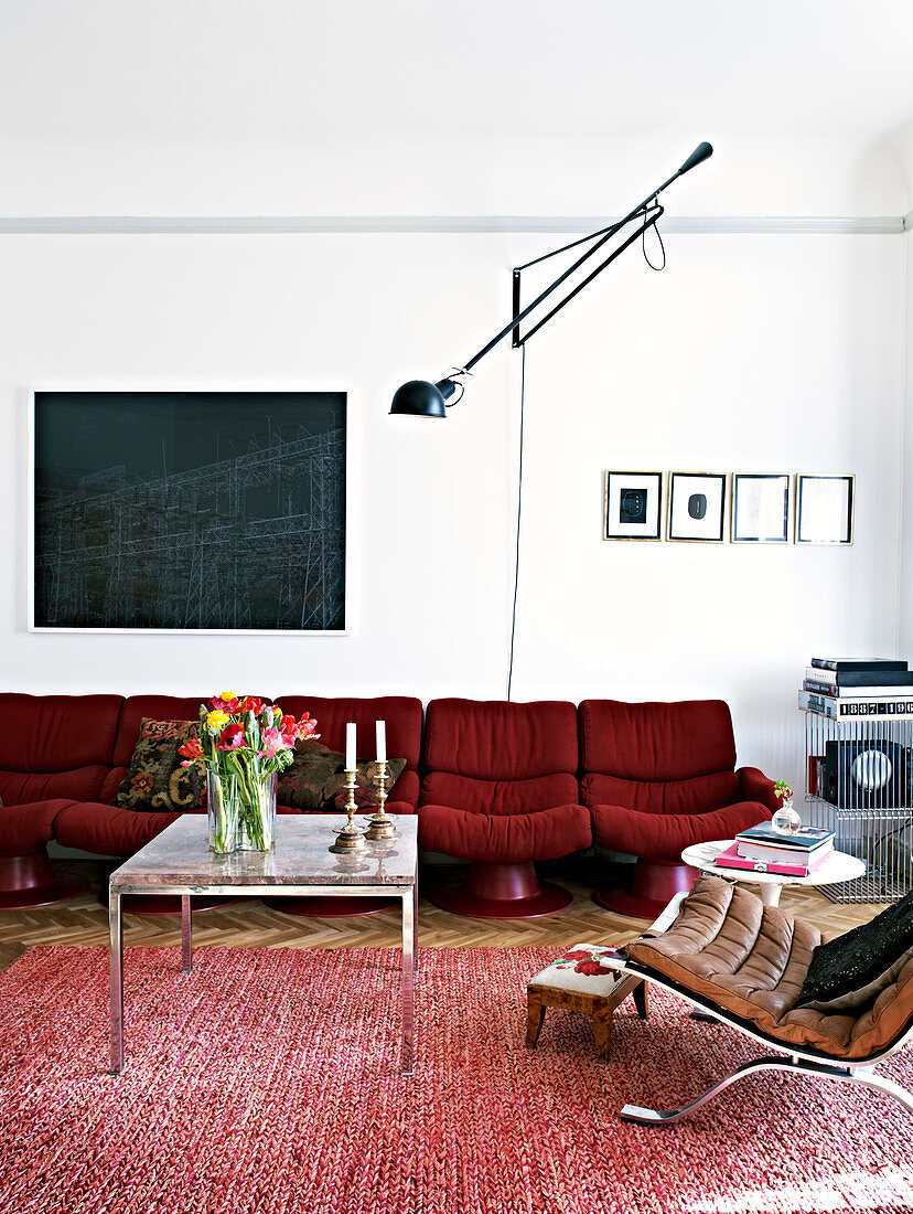 Red retro sofa in the living room with … – License image – 12886423 ...