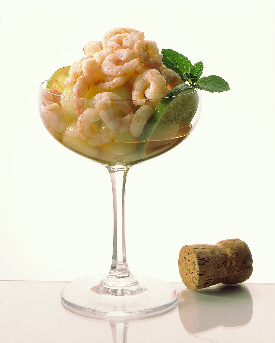 Shrimp cocktail with melon balls, limes