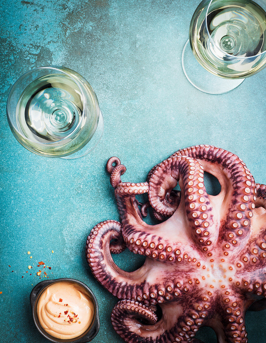 Wineglasses and raw octopus