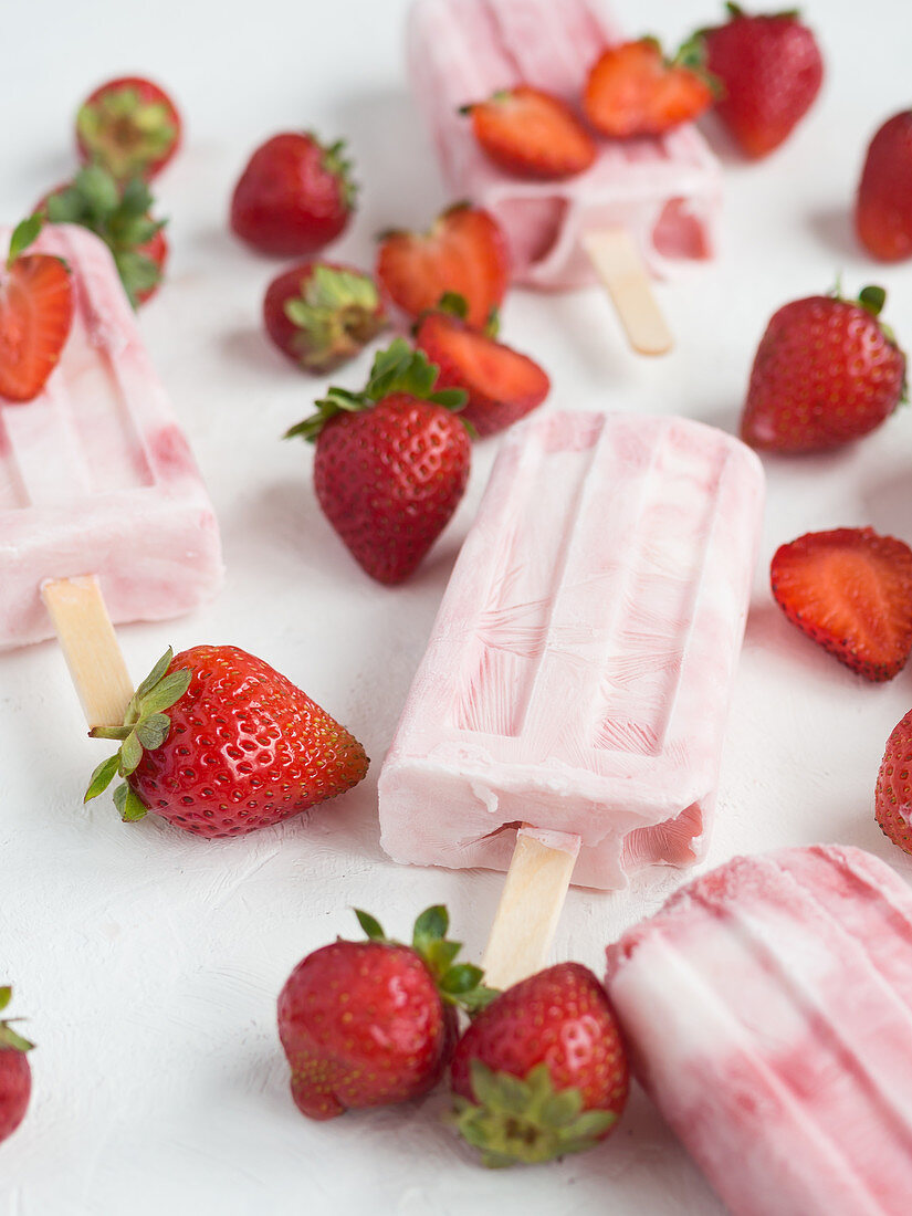 Pink popsicles and fresh strawberries