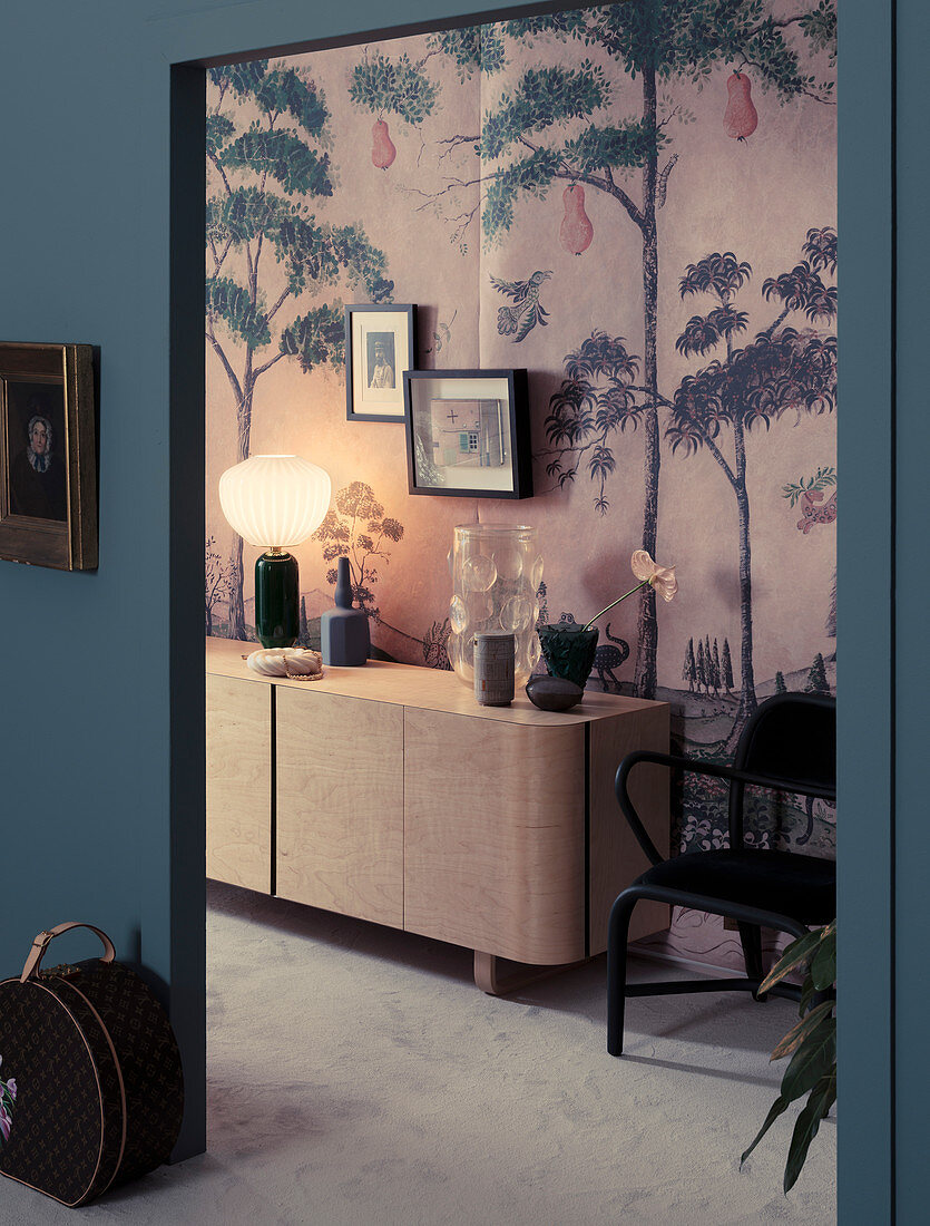 View through opening on sideboard on hallway with wallpaper