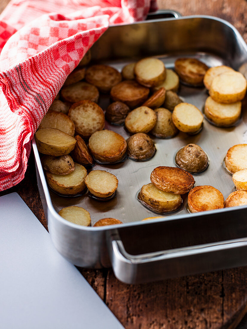 Roast potato in a baking tin