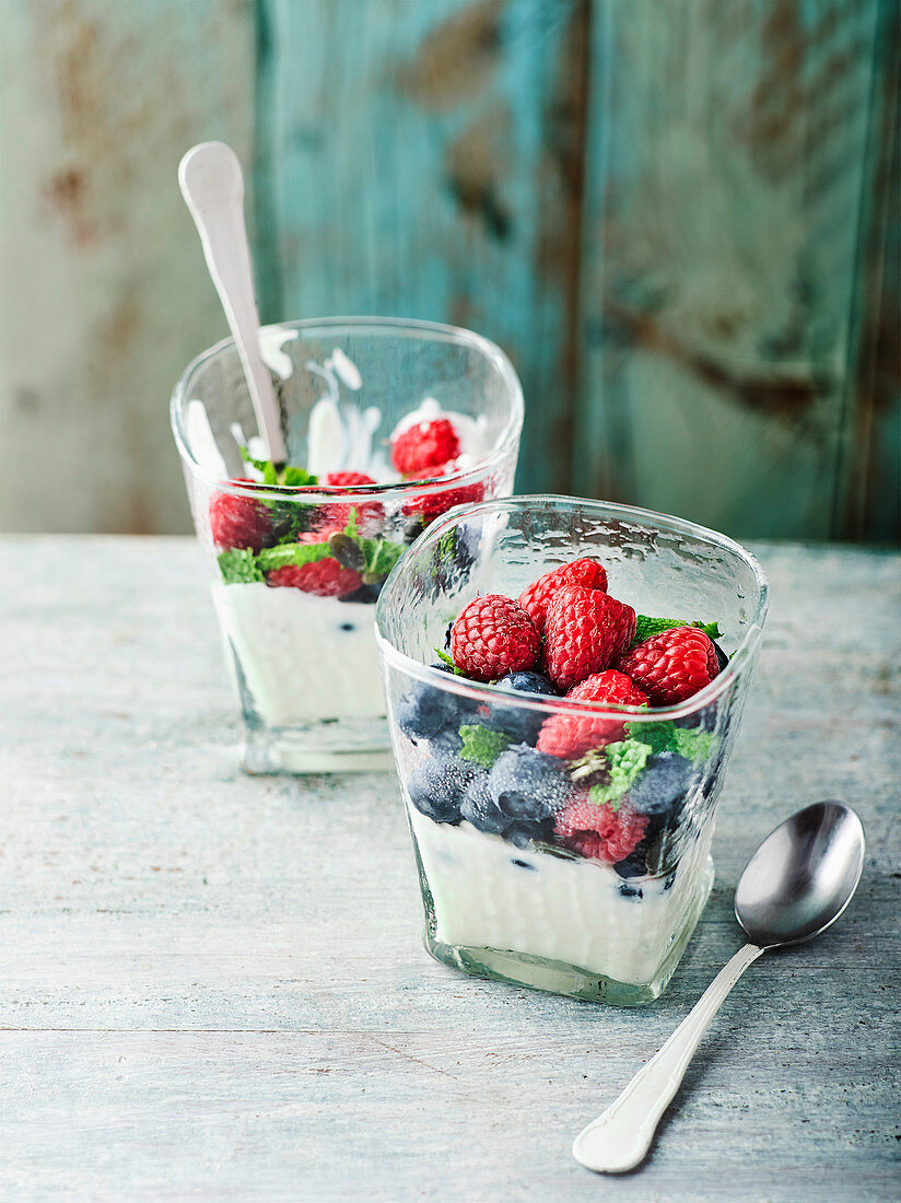 Yogurt cream with fresh berries in glasses