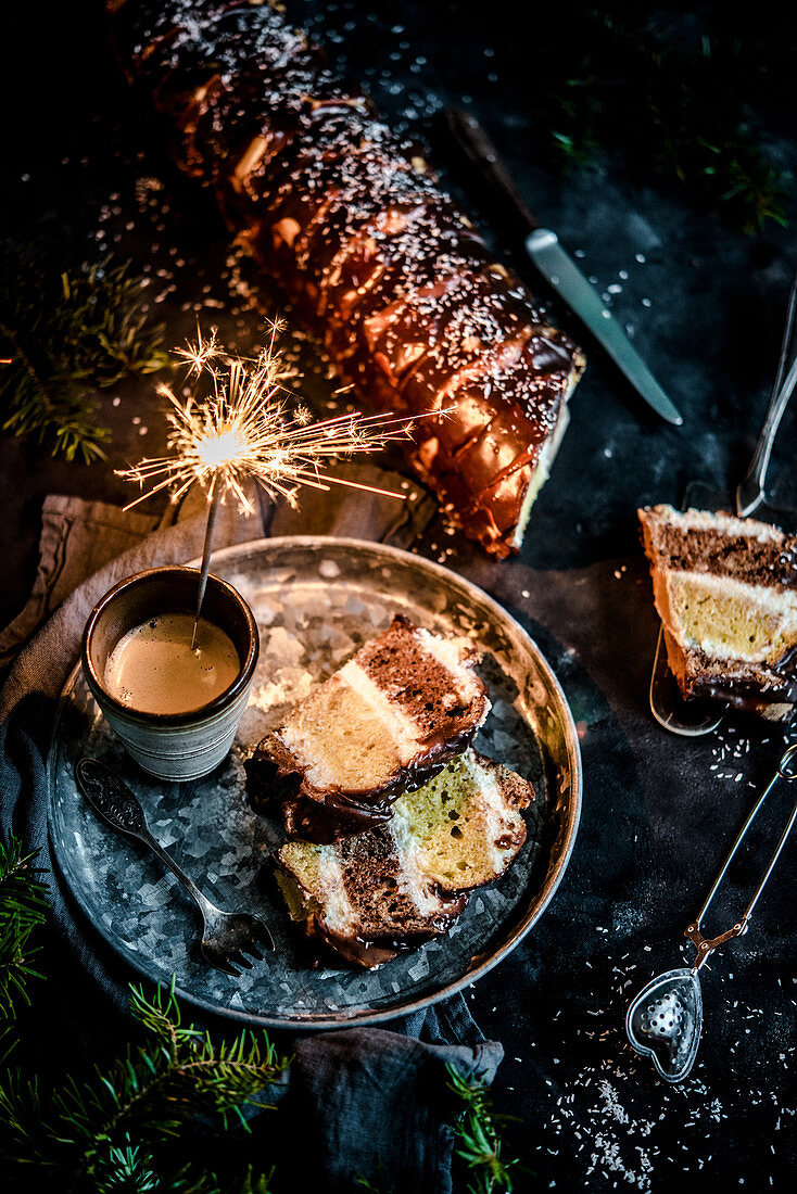 New Year's layered cake covered with chocolate, cold sparkles and coffee