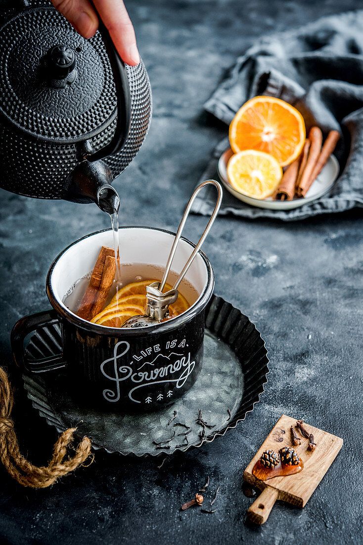 Mulled tea with oranges, cloves, cinnamon and Siberian cones