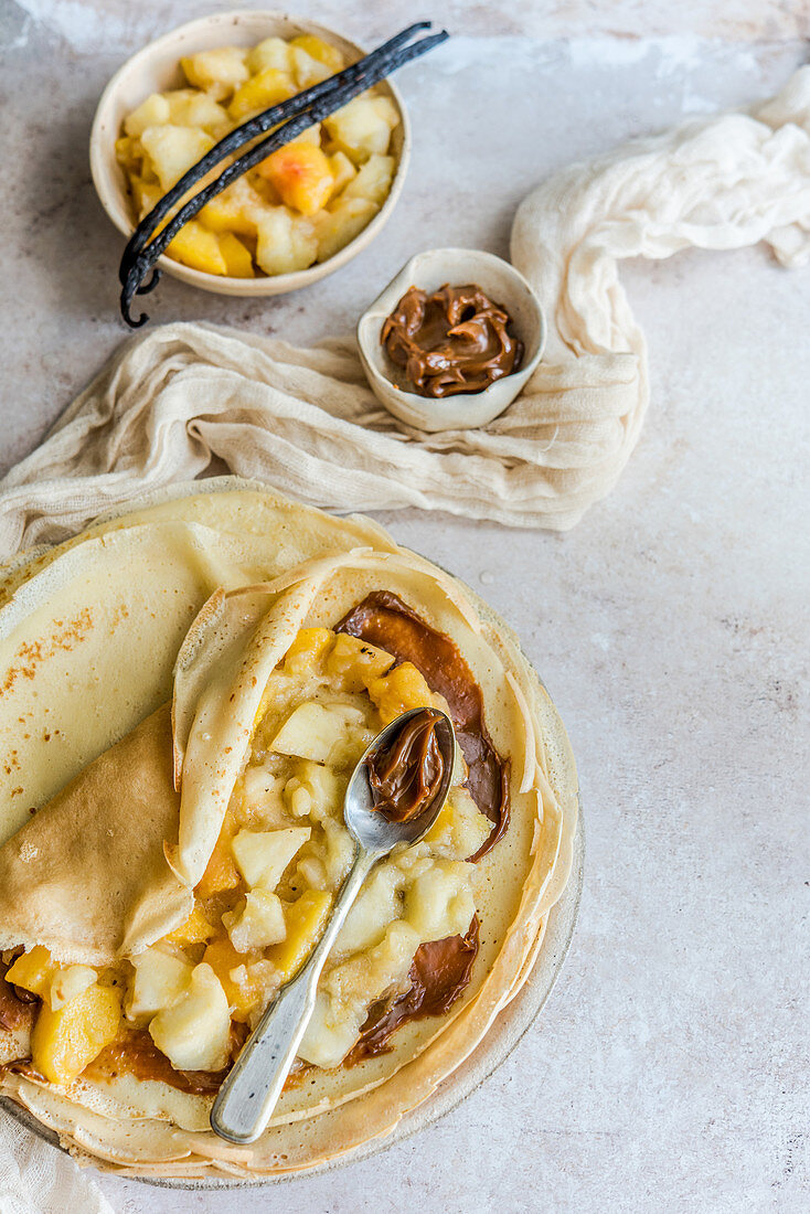 Crepes with caramel sauce, stewed apples with peaches and vanilla