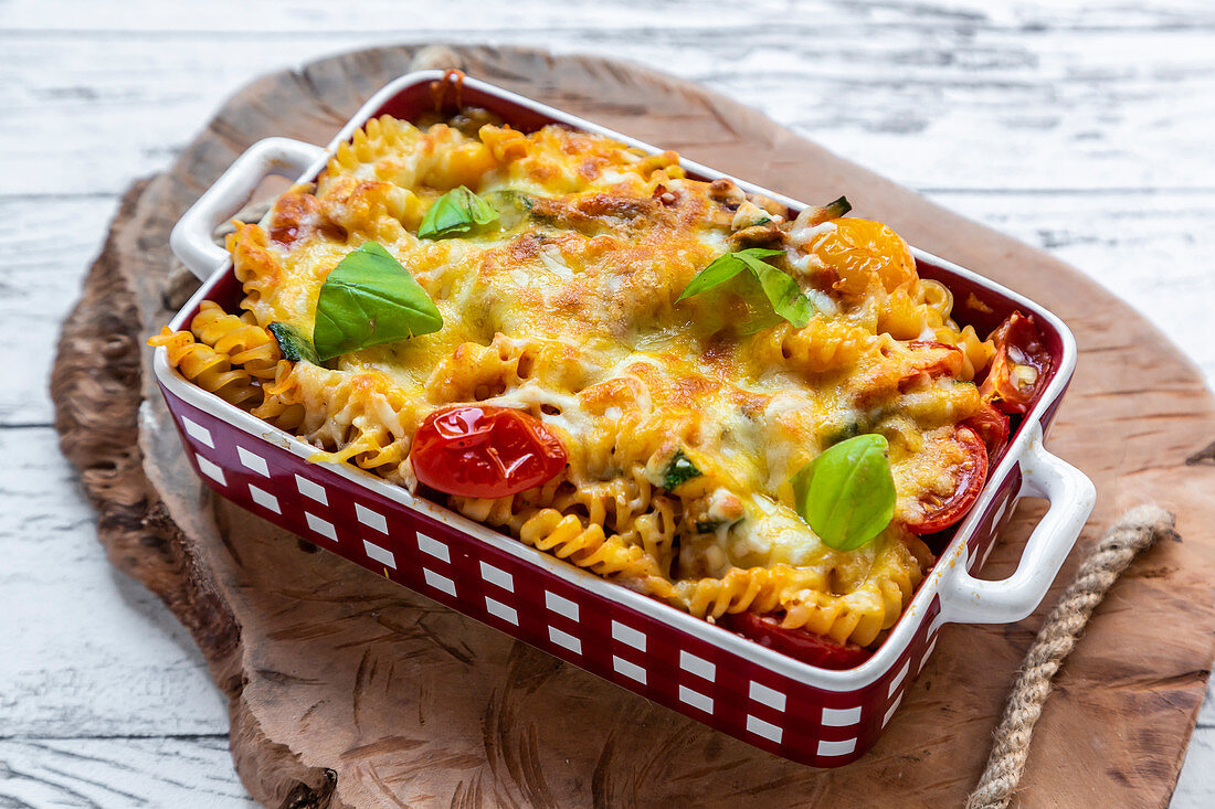 Pasta bake with cheese, tomatoes and basil