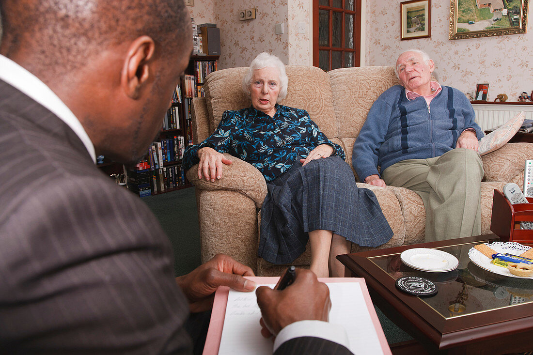Social worker with elderly couple at home