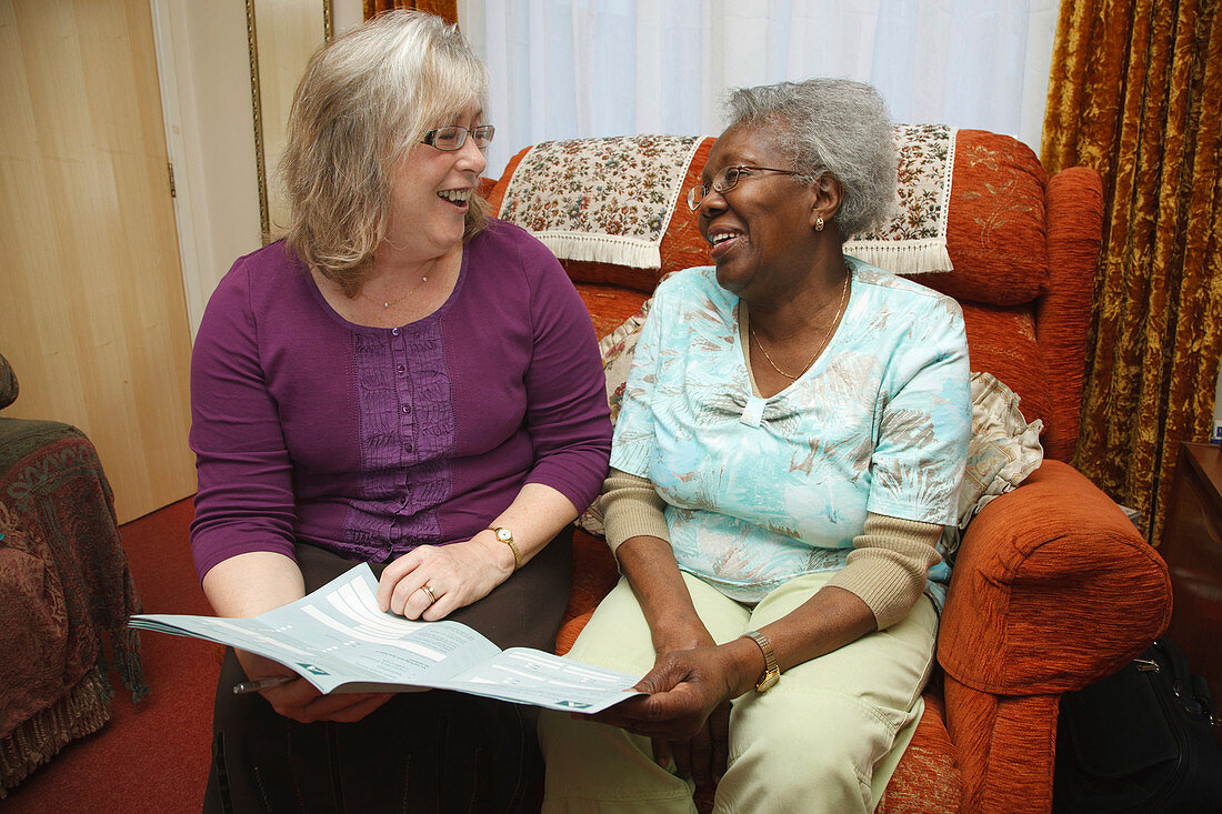 Social worker visiting elderly woman at home