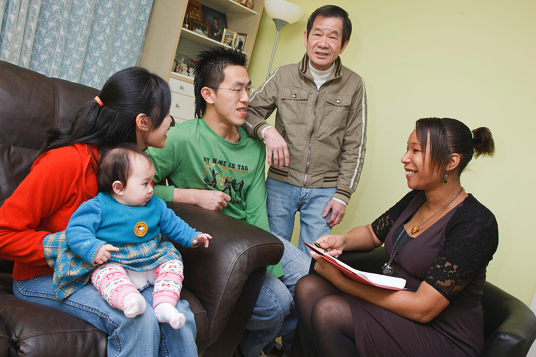 Social worker visiting Chinese family at home