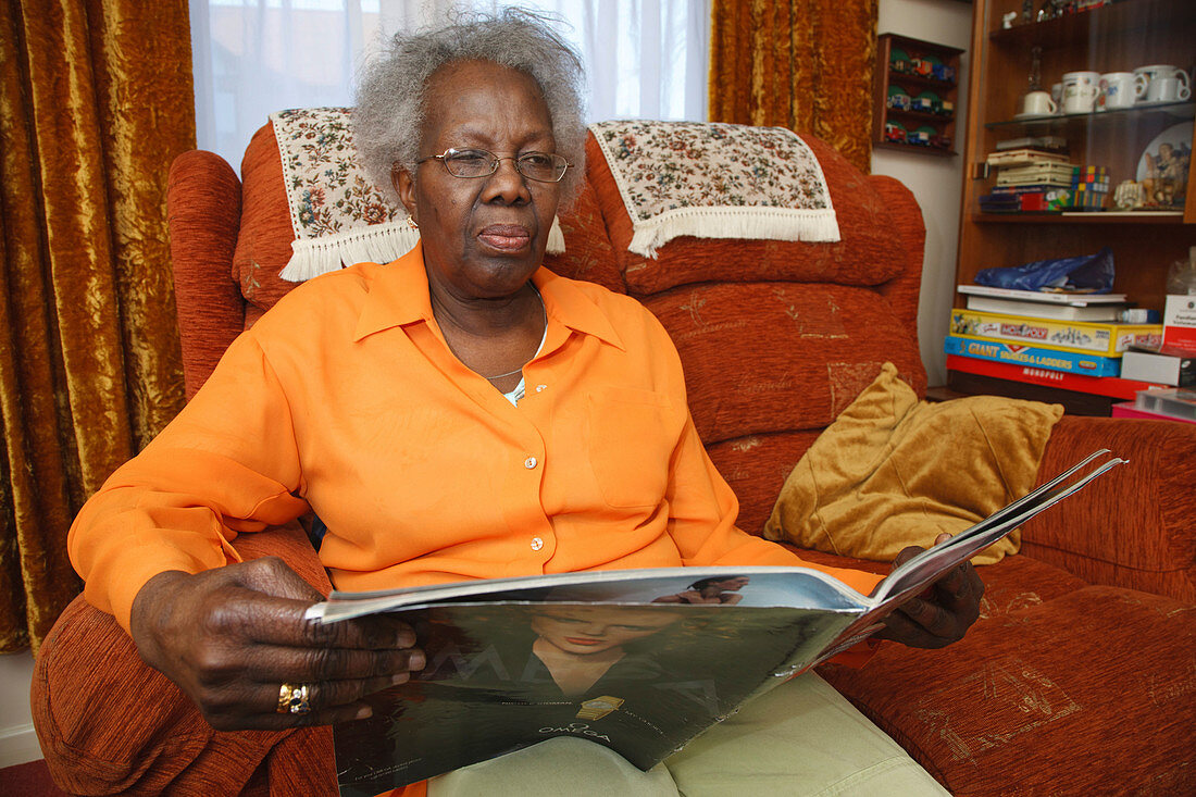 Elderly woman looking at magazine