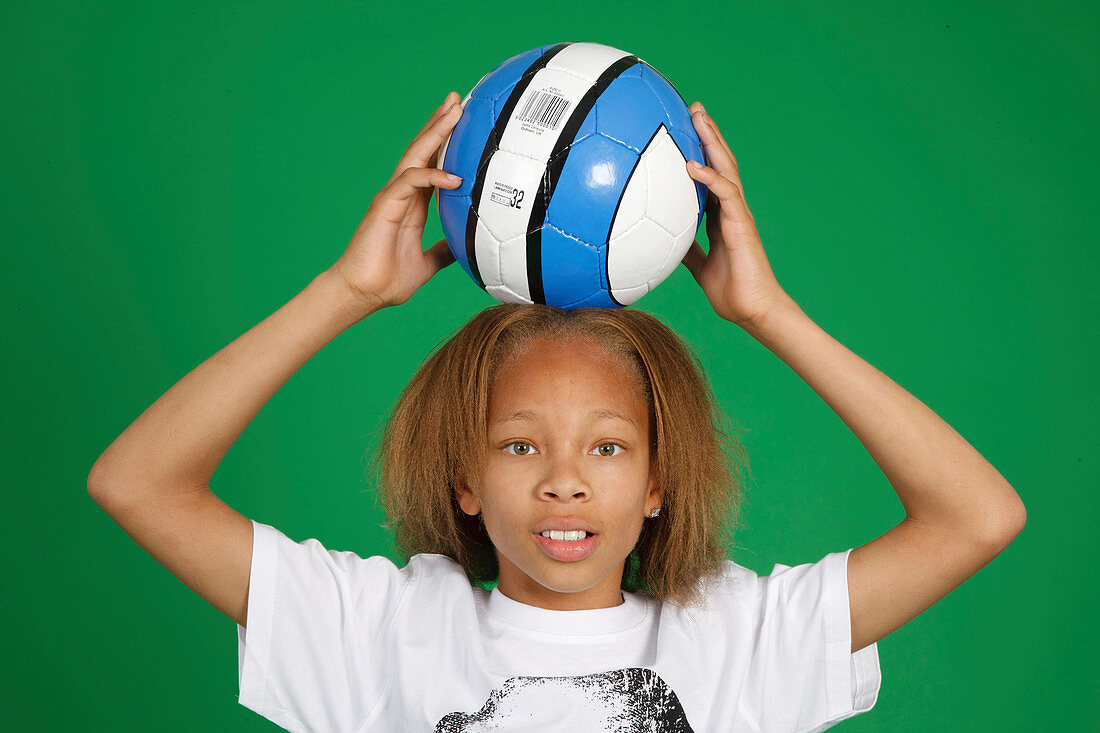 Portrait of boy in sports clothes with basketball