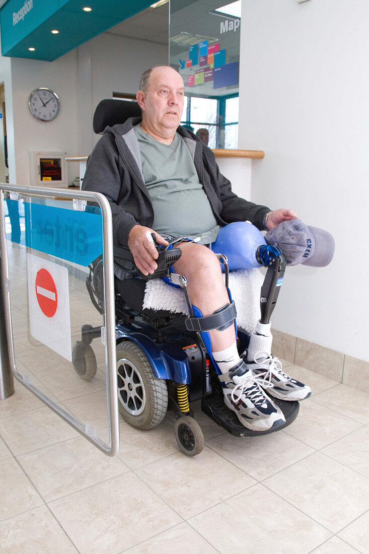 Male wheelchair user going through controlled access gate