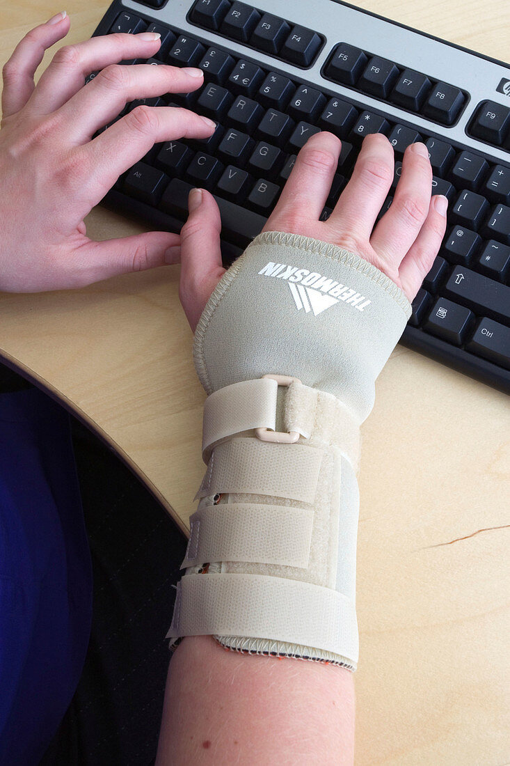 Office worker wearing an elasticated wrist support