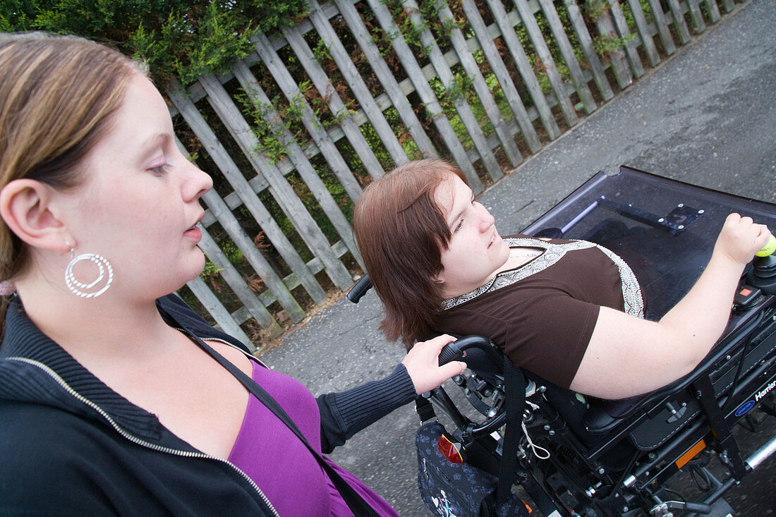 Woman with a disability chatting to her non disabled friend