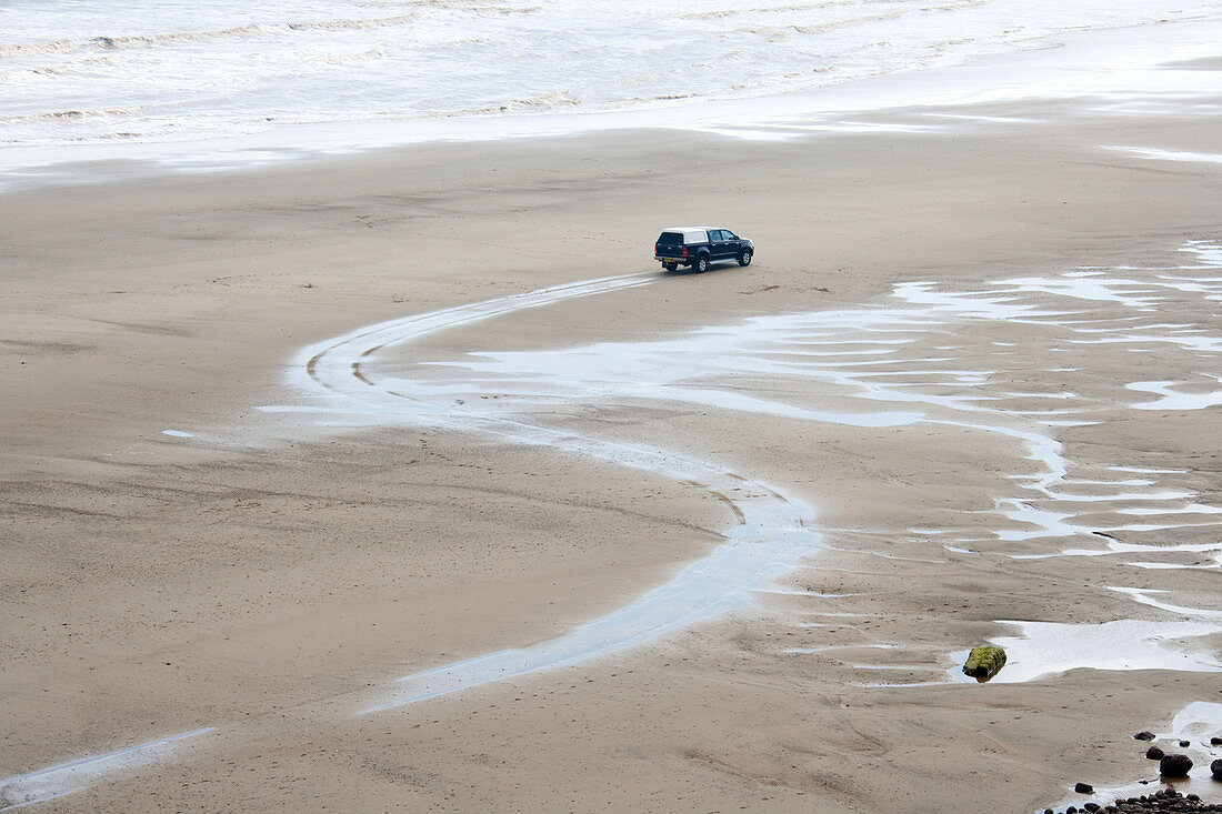 Car on beach at Mappleton,East Yorkshire,UK