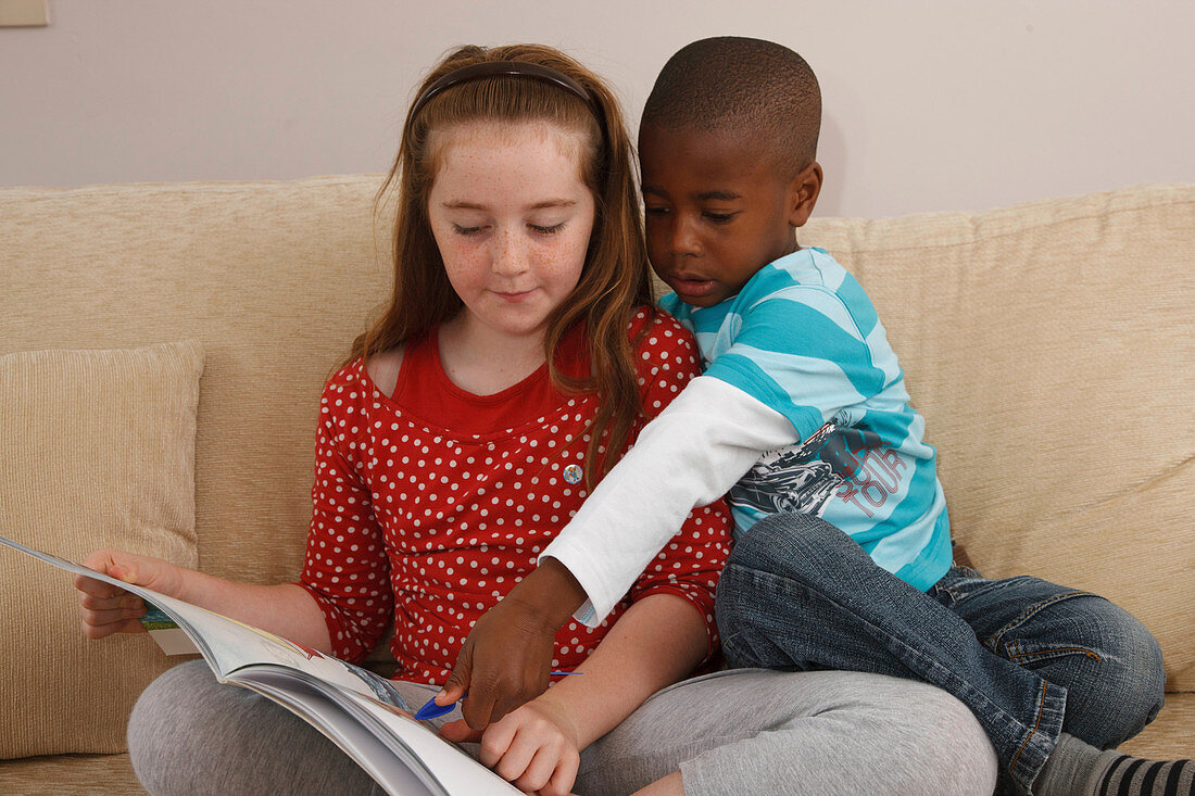 White girl reading to black boy