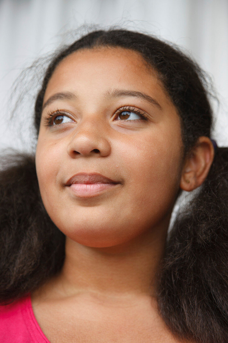 Portrait of mixed race girl looking thoughtful