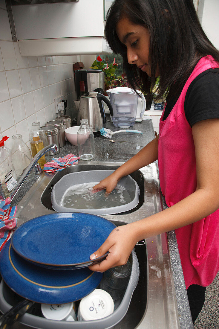Teenager washing up