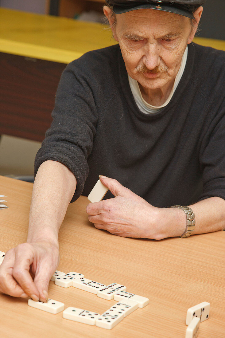 Deaf man with learning disabilities playing dominoes