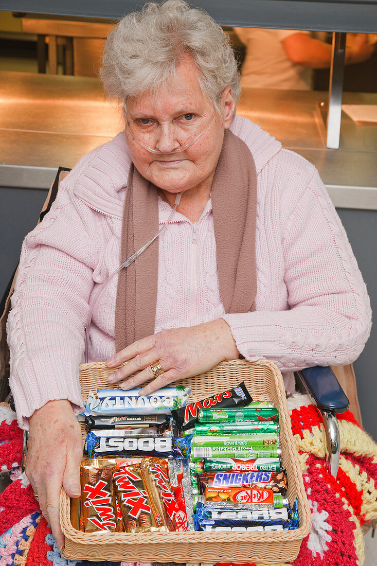 Wheelchair user selling sweets in tuck shop