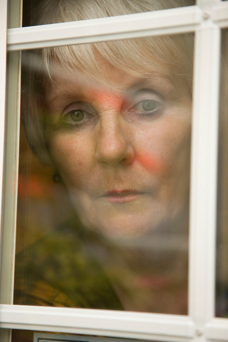 Portrait of an older woman looking out of the window