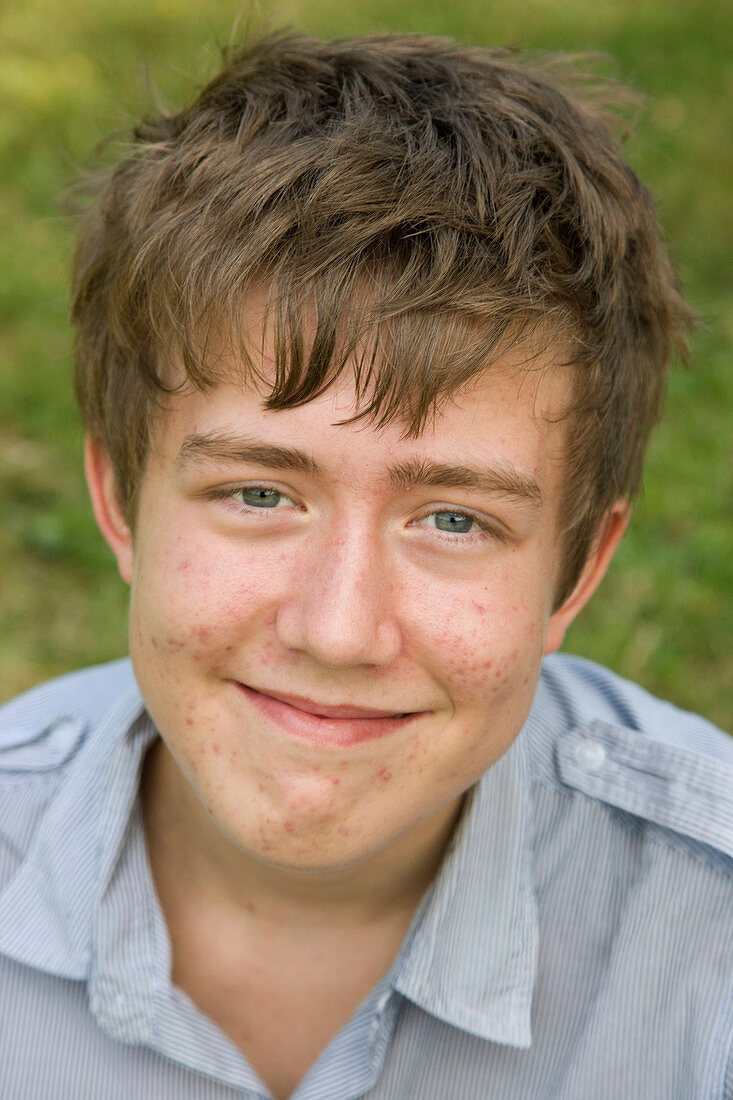 Portrait of a teenage boy smiling in the park