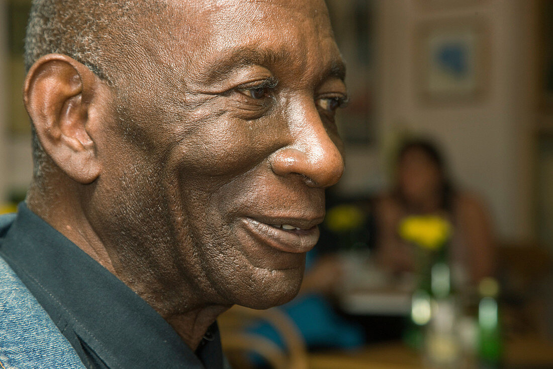 Portrait of an older man sitting in a cafe