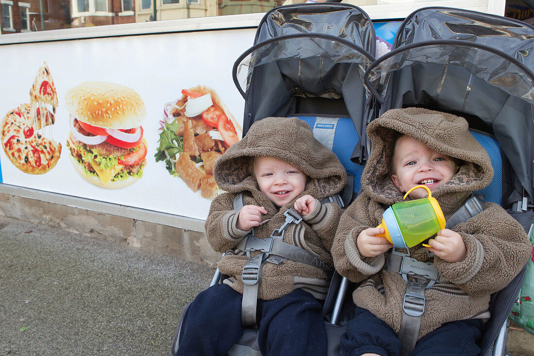 Twins in buggy outside chip shop