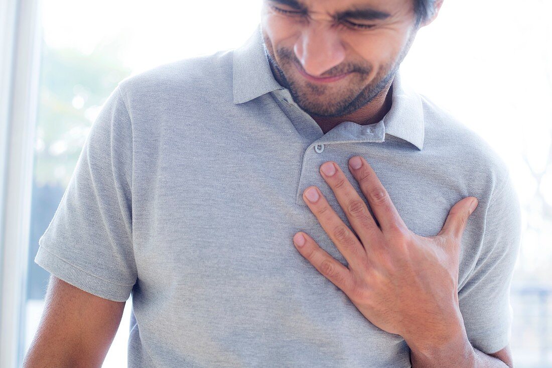 Man touching his chest in pain