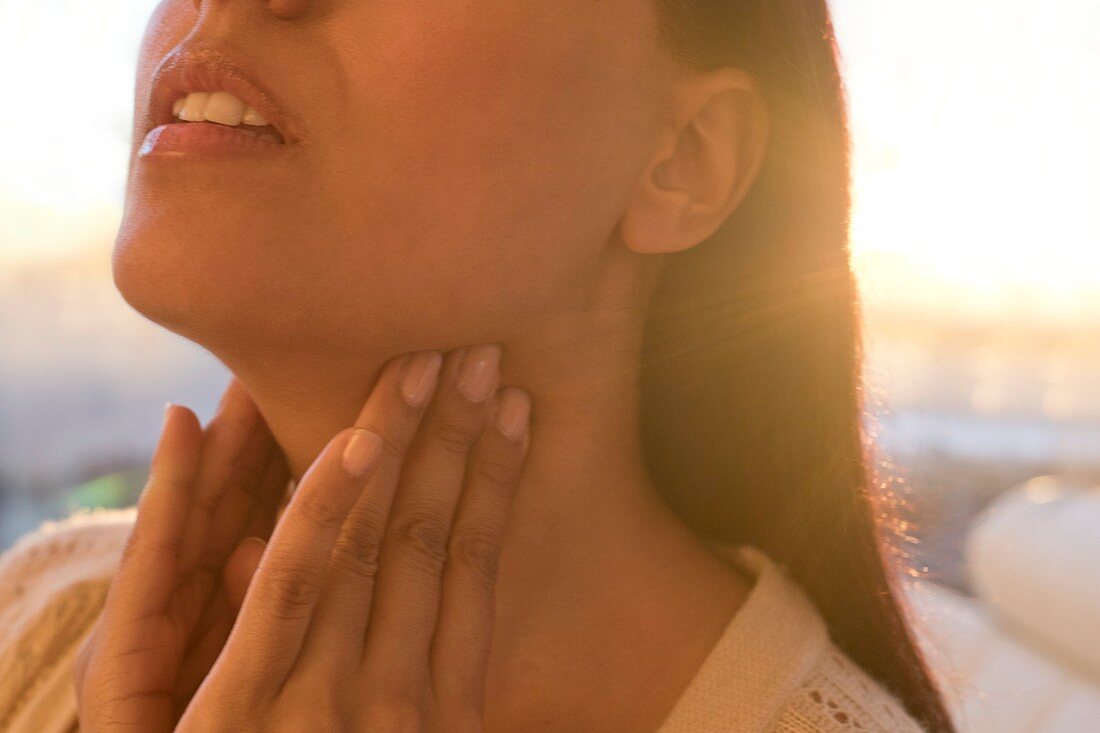 Woman touching neck