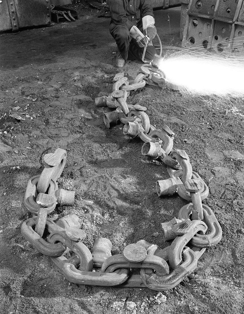 Cutting off lead from a manganese chain casting, 1965
