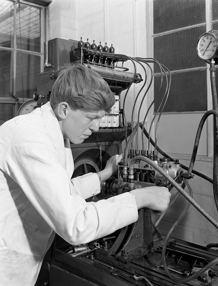 Apprentice at work in auto electrical workshop, 1961