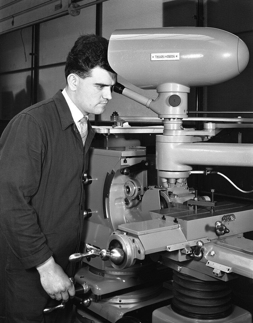 Worker using a cutting machine, 1964