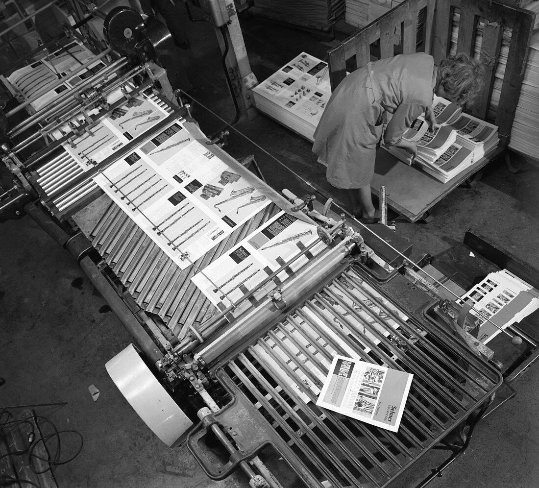 Stacking finished brochures at a printers, 1959