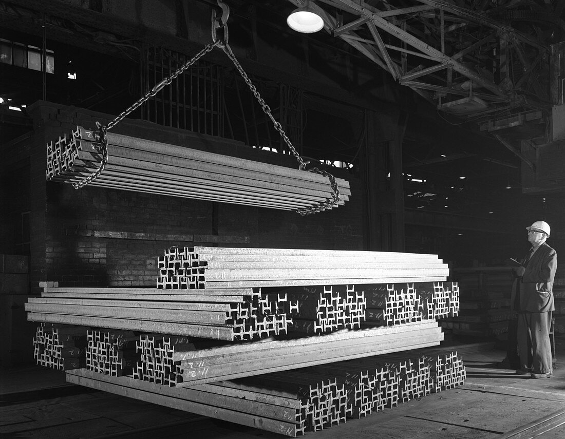 Steel H girders being stacked for distribution, 1964