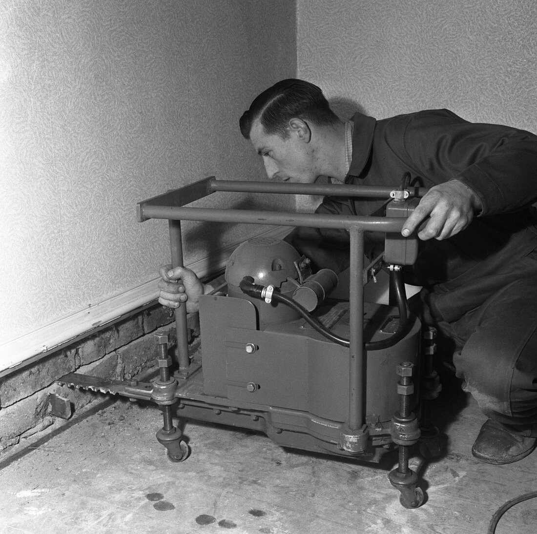 Installing a damp proof course in a house, 1957