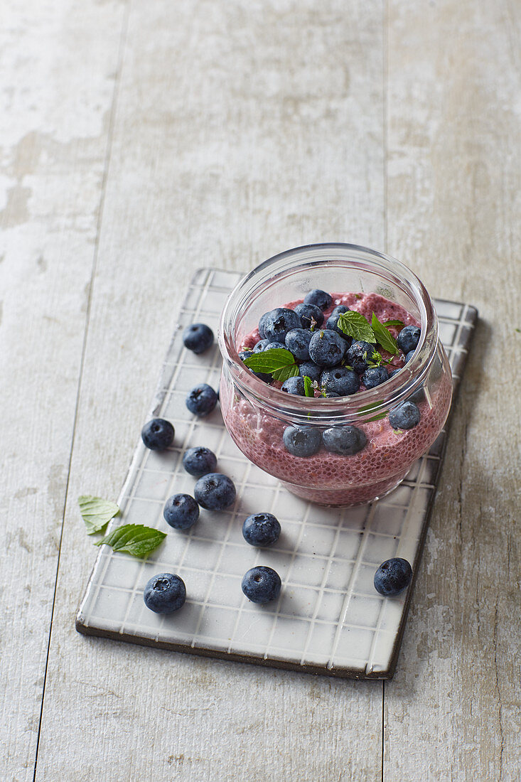 Vegan raspberry and coconut dessert with chia seeds and blueberries