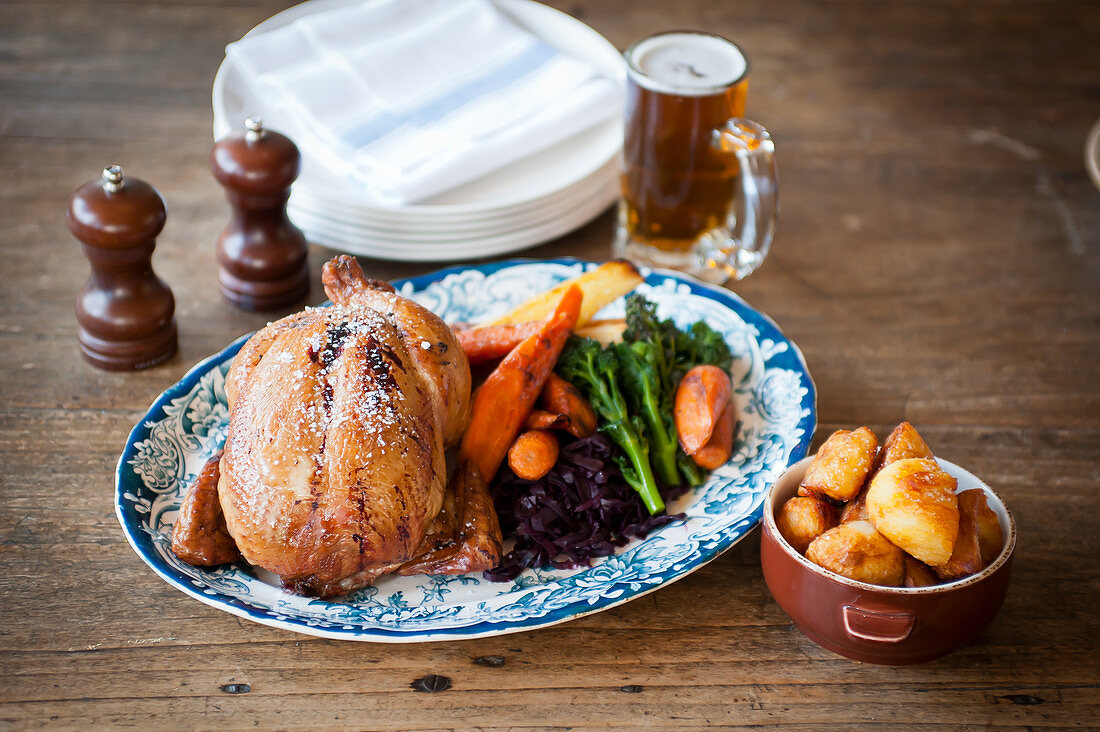 A whole roast chicken with vegetables