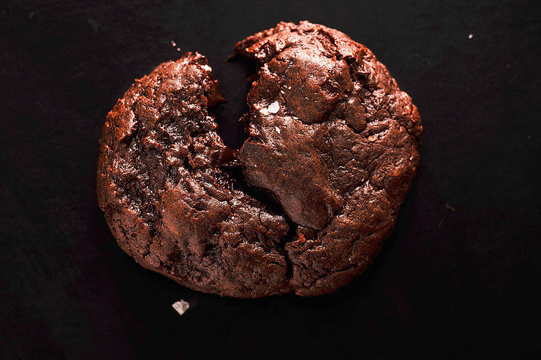 Broken soft chocolate cookie with salt flakes