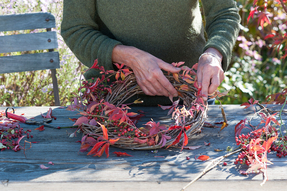 Autumn wreath with rose hips and wild wine