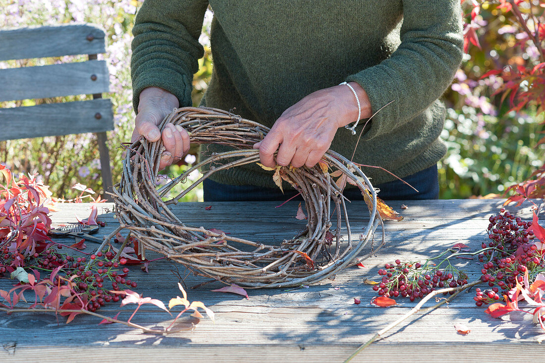 Autumn wreath with rose hips and wild wine