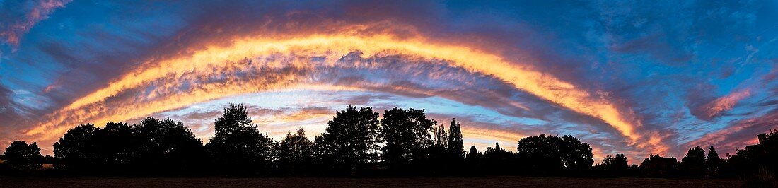 Altocumulus stratiformis cloud arch at sunset