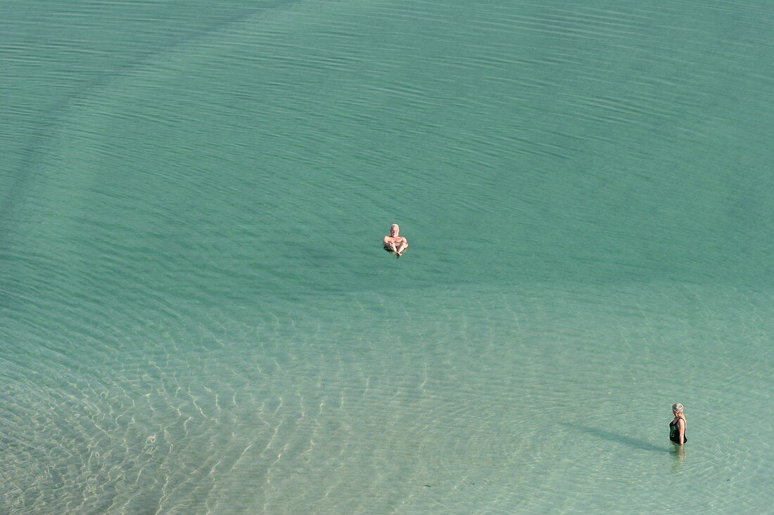 Tourists float in the Dead Sea