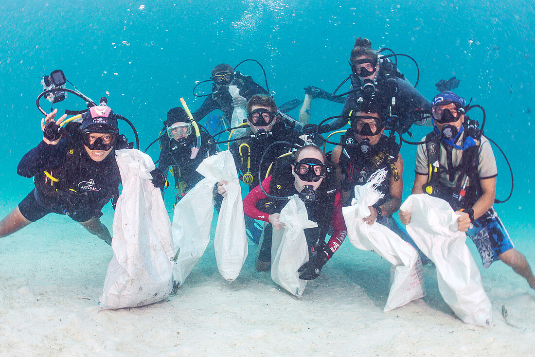 Scuba divers collecting plastic waste