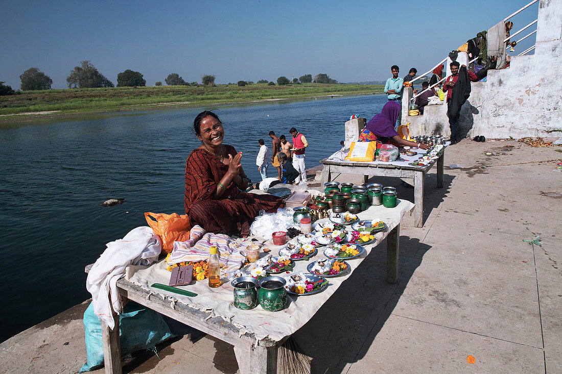 Traders by Indian riverside temple
