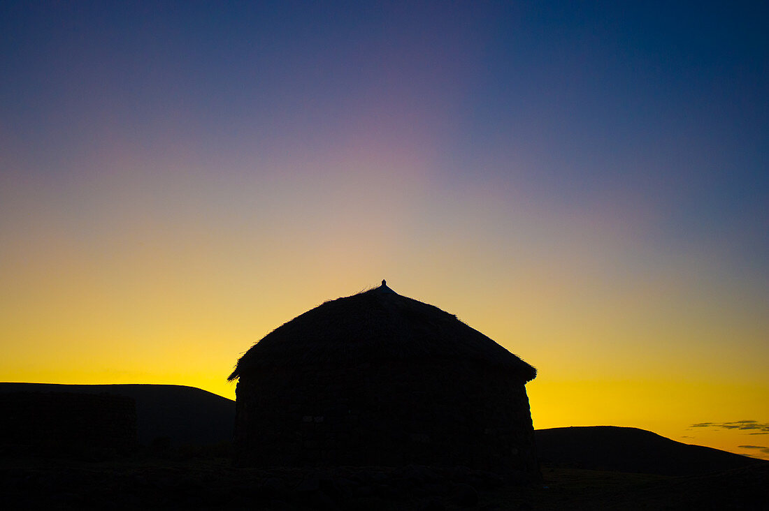 Silhouette of huts in front of the sunset, Lesotho