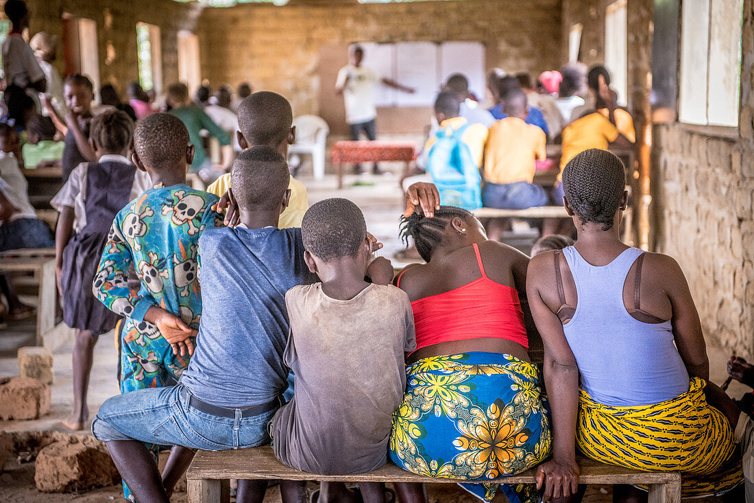 Adults and children in a classroom, Ganta, Liberia
